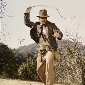 Adventurer with whip in outdoor setting.