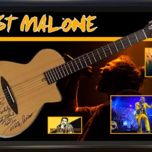 Framed signed guitar with musician images.