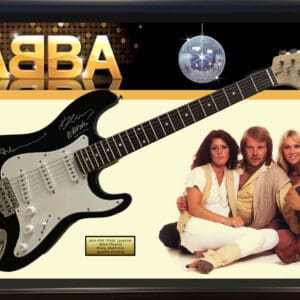 Signed guitar with ABBA group photo.