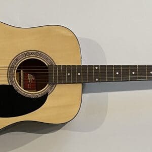 Acoustic guitar with a signed message.