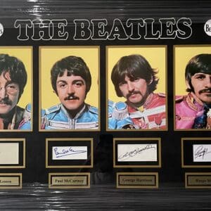 The Beatles portraits with autographs display.