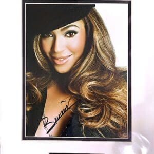 Smiling woman with long hair and hat.