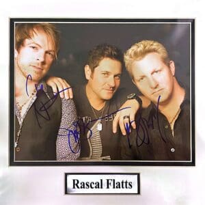 Three men with autographs, labeled Rascal Flatts.