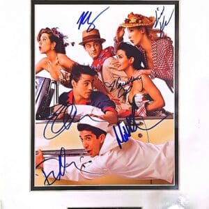 Cast of TV show in vintage car.