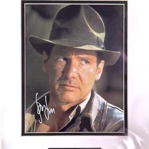 Man in fedora with intense expression.