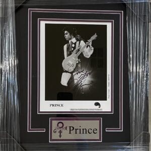 Framed photograph of musician with guitar.