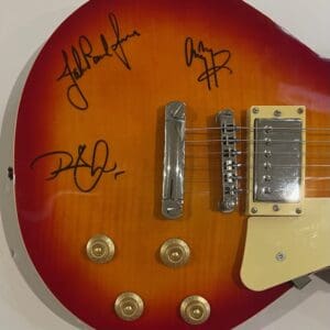 Close-up of signed electric guitar body.