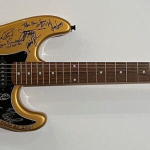 Gold electric guitar with multiple signatures.