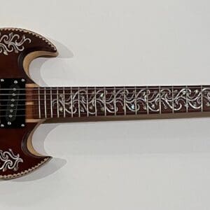 Ornate electric guitar with intricate decorative patterns.