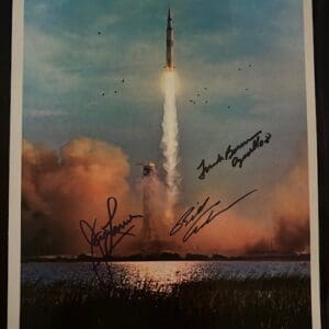 Apollo 8 launch with astronaut signatures.