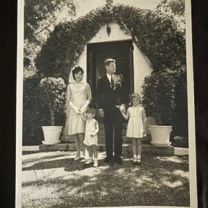 Family standing outside a house entrance.