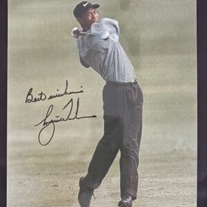 Golfer swinging club on a golf course.