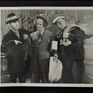 Three men in vintage comedic scene.