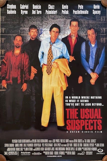 Movie poster with five men standing.