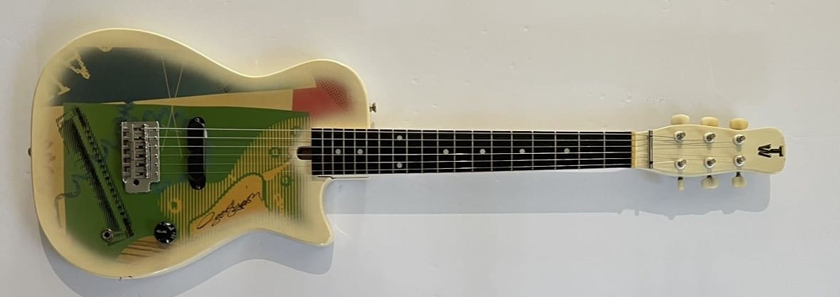 Vintage electric guitar with colorful abstract design.