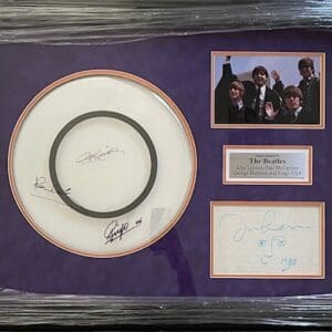 Framed Beatles memorabilia with autographs and photo.