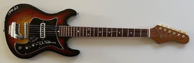 Autographed electric guitar with sunburst finish.