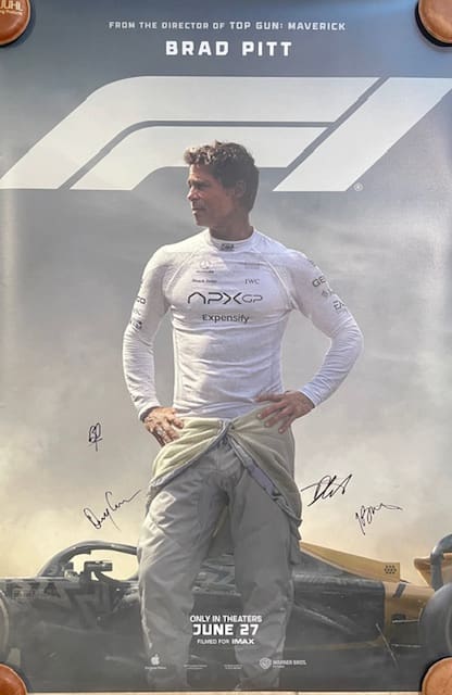 Race car driver standing with hands on hips.