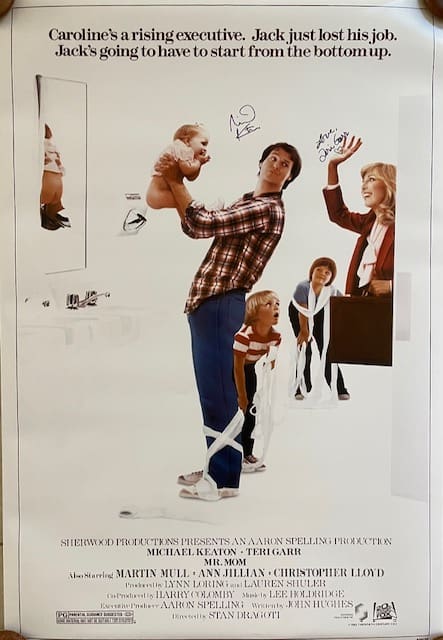 Man holding baby with woman and children.