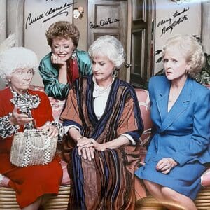 Four women sitting on a floral couch.