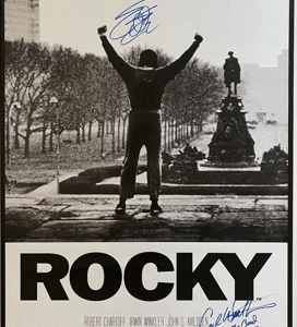 Boxer celebrating on steps, "Rocky" movie poster.