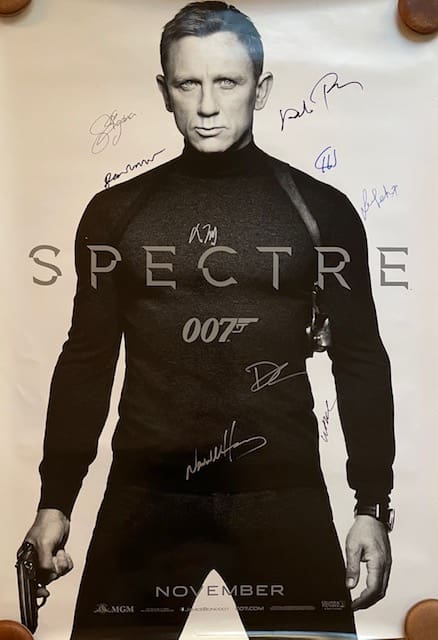 Movie poster with autographs and 007 logo.