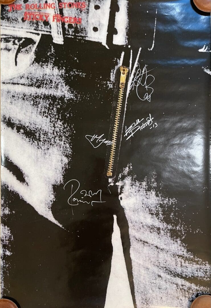 Close-up of album cover with signatures.