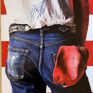 Jeans and cap against American flag background.