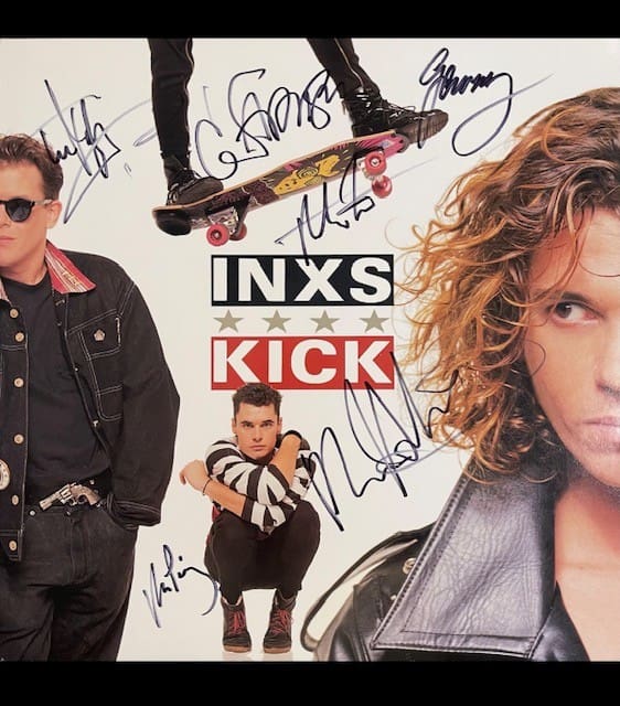 Album cover with signatures and band members.