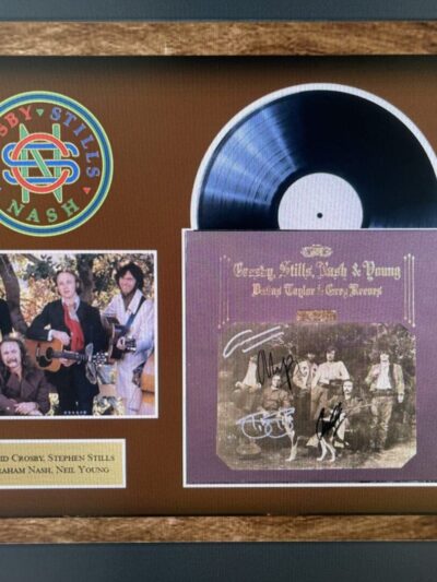 Framed album and photo of music group.