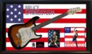 Guitar with Bruce Springsteen memorabilia display.