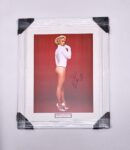 Framed signed photo of woman in bodysuit.