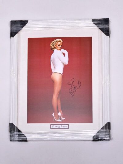 Framed signed photo of woman in bodysuit.