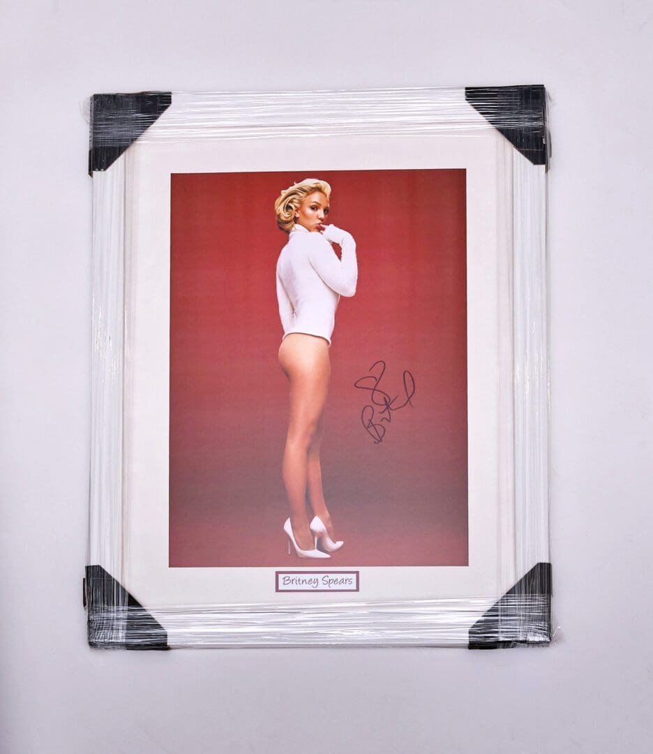 Framed signed photo of woman in bodysuit.
