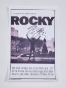 Signed Rocky movie poster with iconic scene.