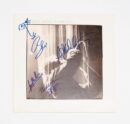 Signed album cover with black-and-white photo.