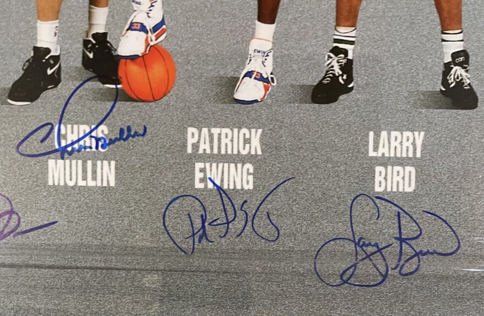 Basketball players' shoes with signatures and names.