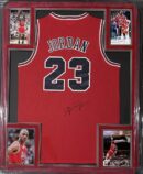 Red basketball jersey with signed photographs.