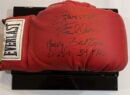 Red boxing glove with autographs on display.