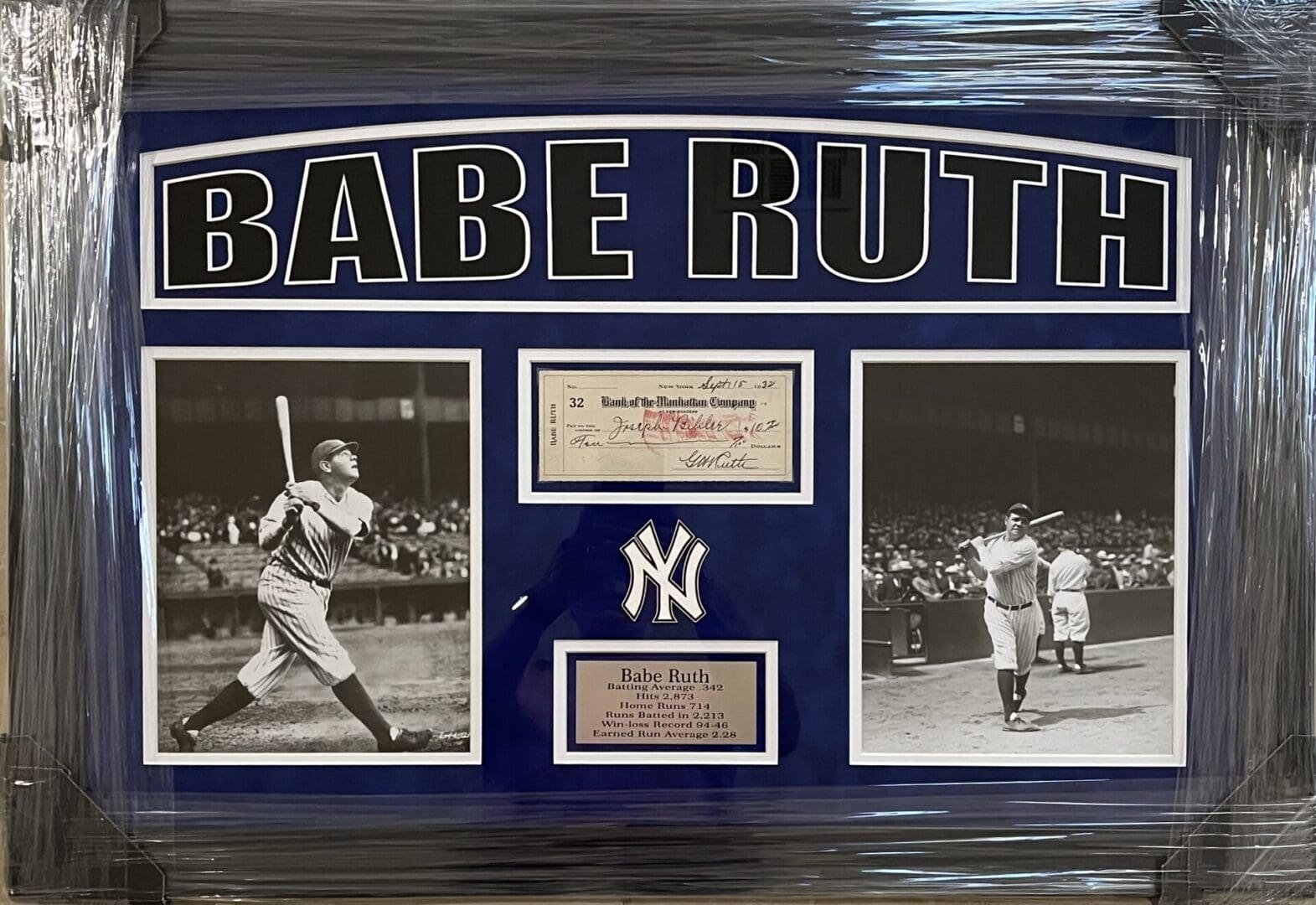 Framed Babe Ruth memorabilia with photos and check.