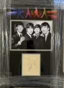 Framed black-and-white band photo with signatures.