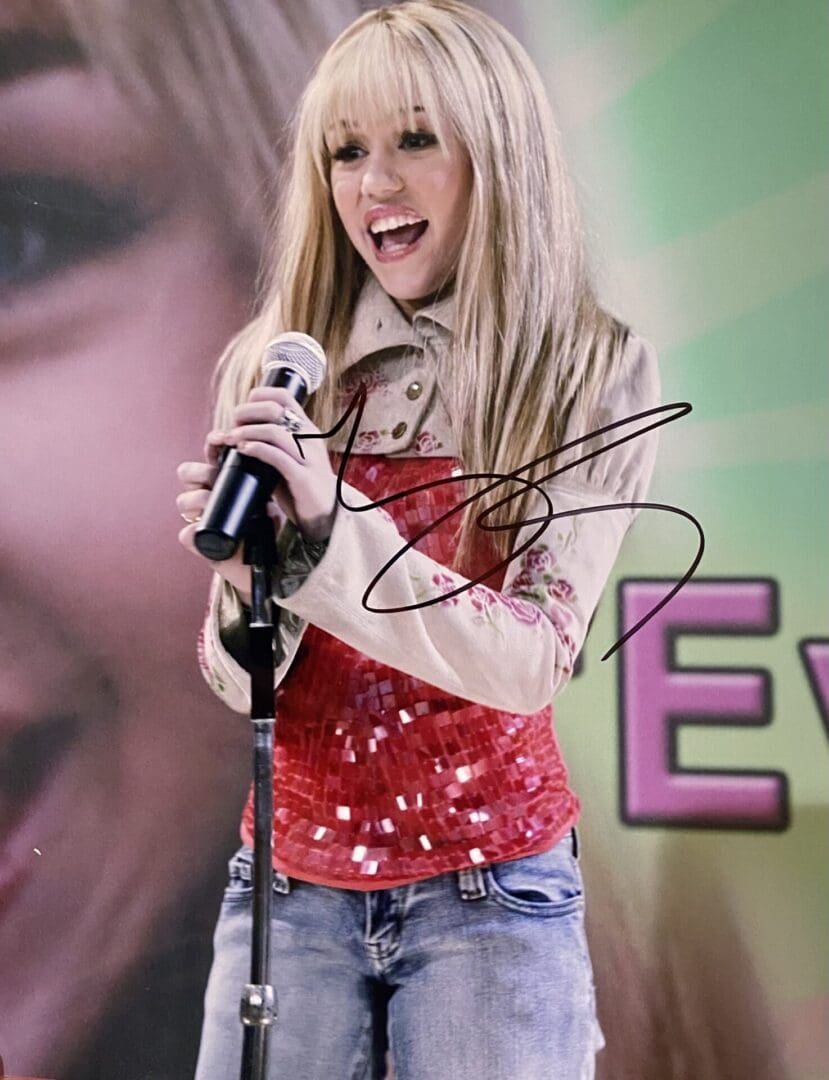 Young woman singing with a microphone.