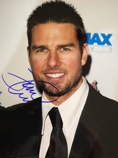 Man in suit with autograph on photograph.