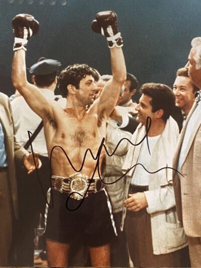 Boxer celebrating victory with supporters around.