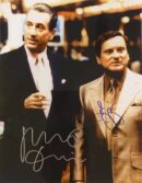 Two men in suits with autographs.