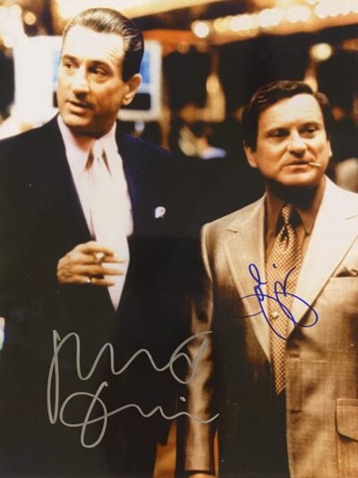 Two men in suits with autographs.