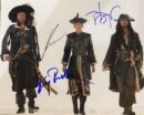 Three pirates walking on sandy ground.