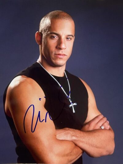Man with crossed arms wearing black shirt.