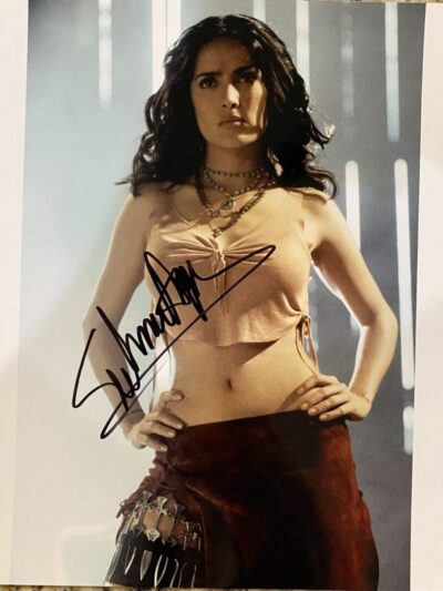 Woman posing with signed photograph.
