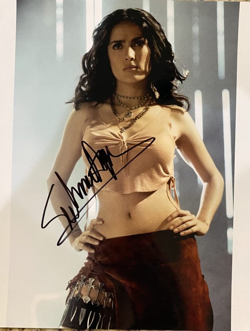 Woman posing with signed photograph.
